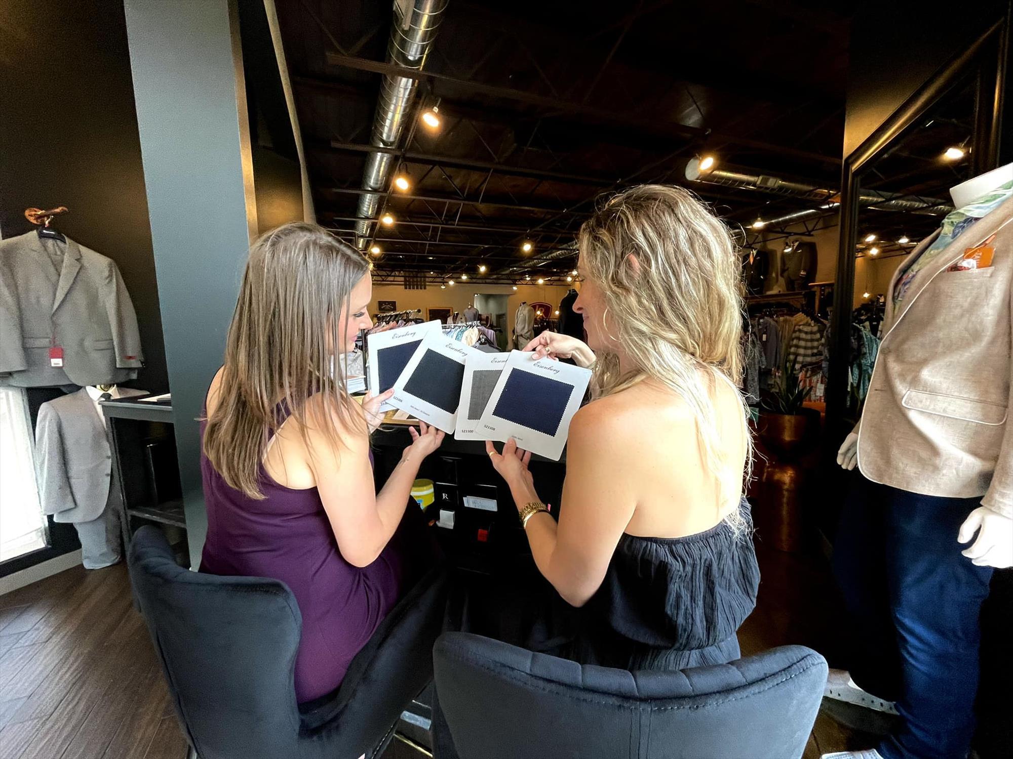 Danielle and Anna looking at different clothing textiles